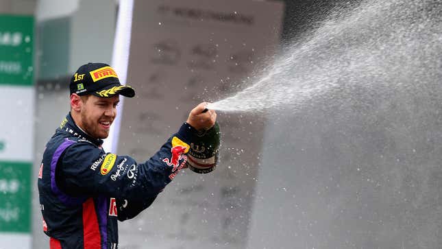 A photo of Sebastian Vettel spraying Champagne on the podium. 