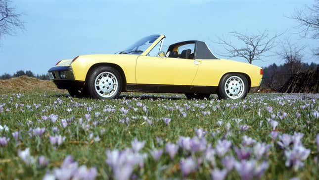 A photo of a yellow Porsche 914 with its roof down. 