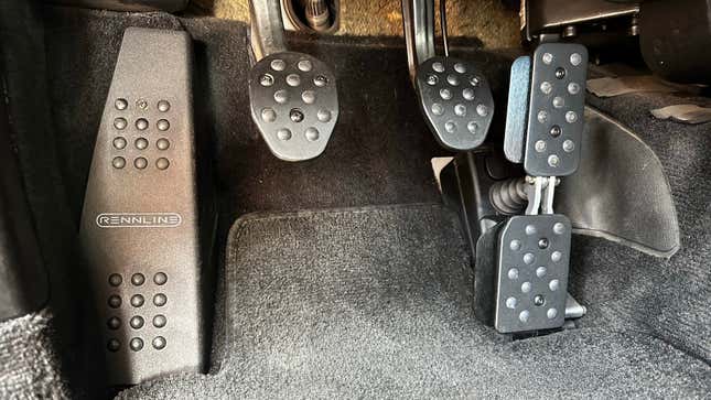 Black racing pedals are installed in a 2003 Porsche 911 Carrera