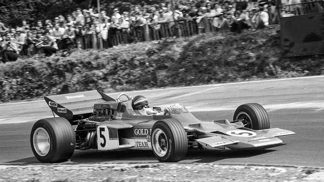 A black and white photo of Jochen Rindt racing in F1. 