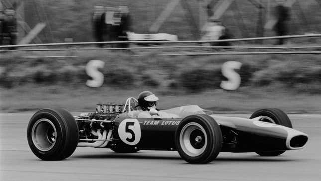 A black and white photo of Jim Clark in his Lotus F1 car. 